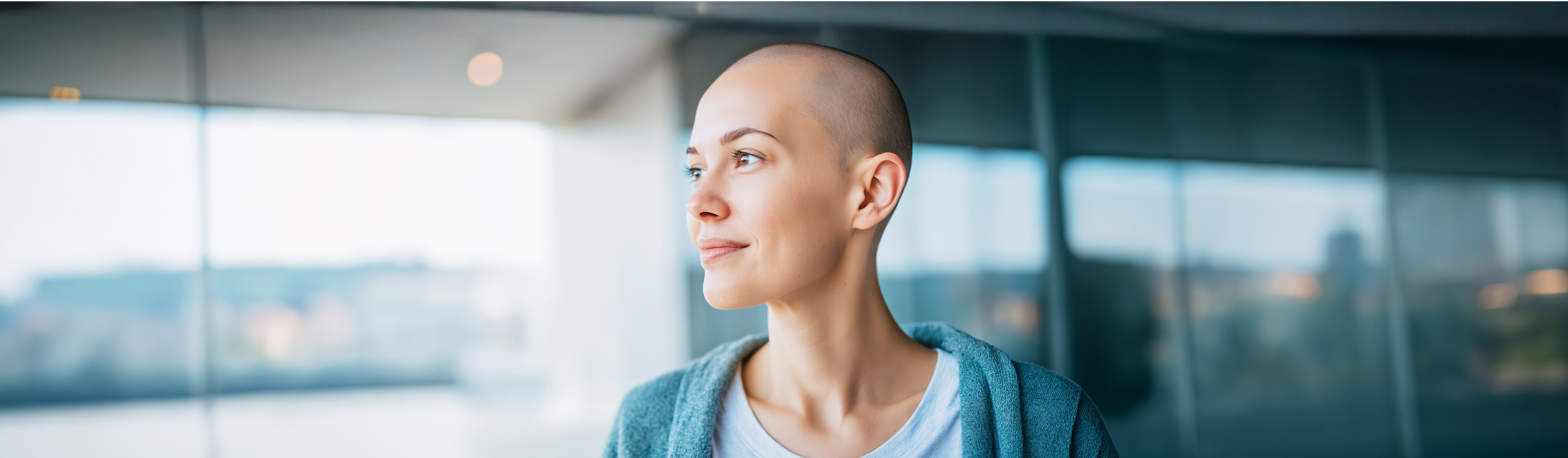 Bald woman in blue with determined gaze