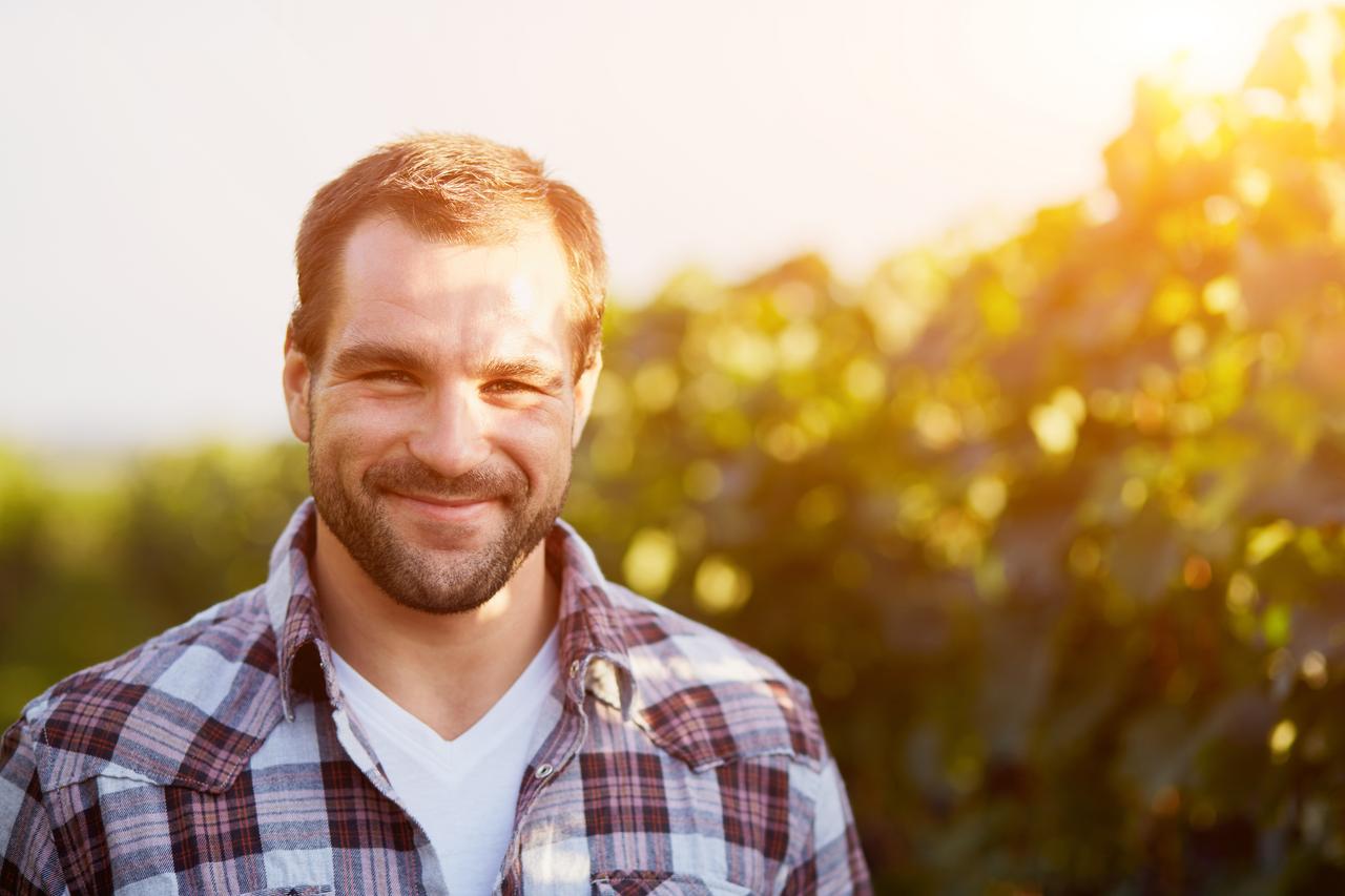 Man in checed shirt in garden