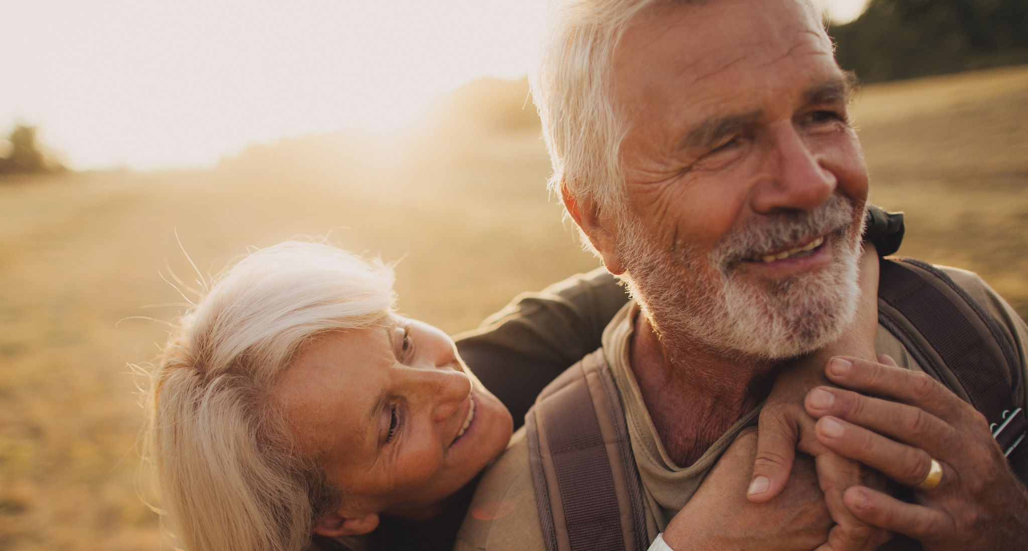 Photo of an elderly couple, who still enjoy in each other, is on a hiking trip together