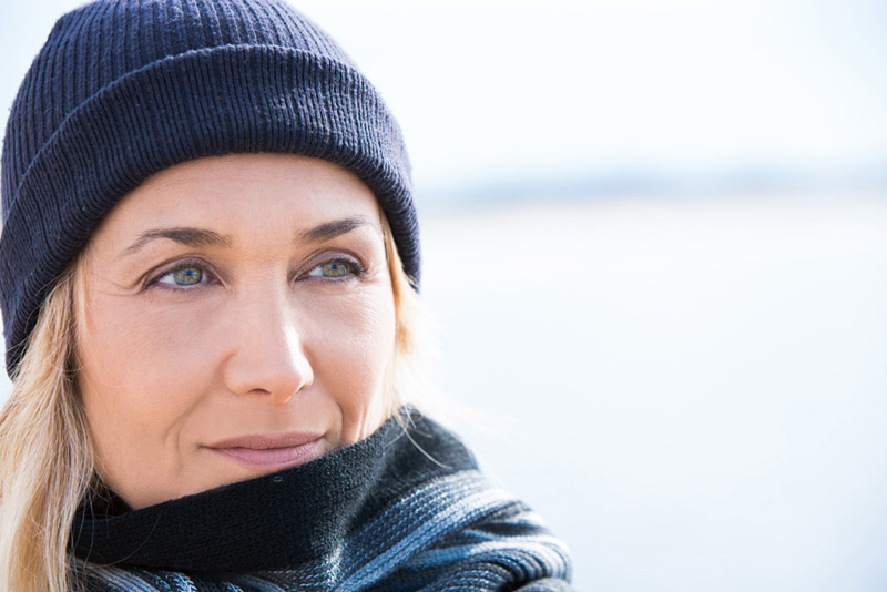 portrait of a senior woman with a wool cap in winter