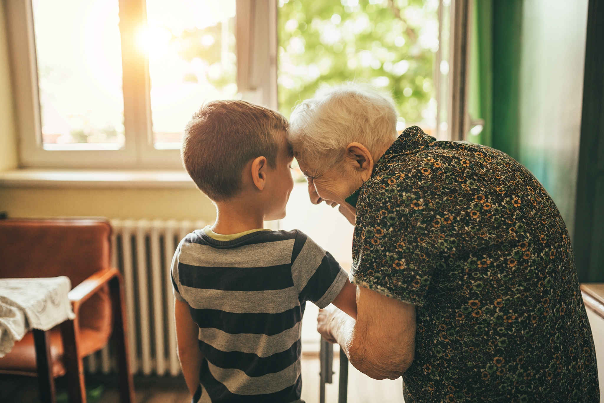 A photo of grandson spending time with his great-grand mother