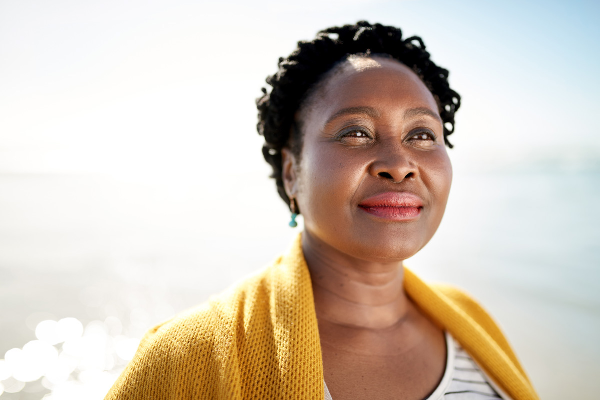 Shot of a mature woman enjoying a day at the beach