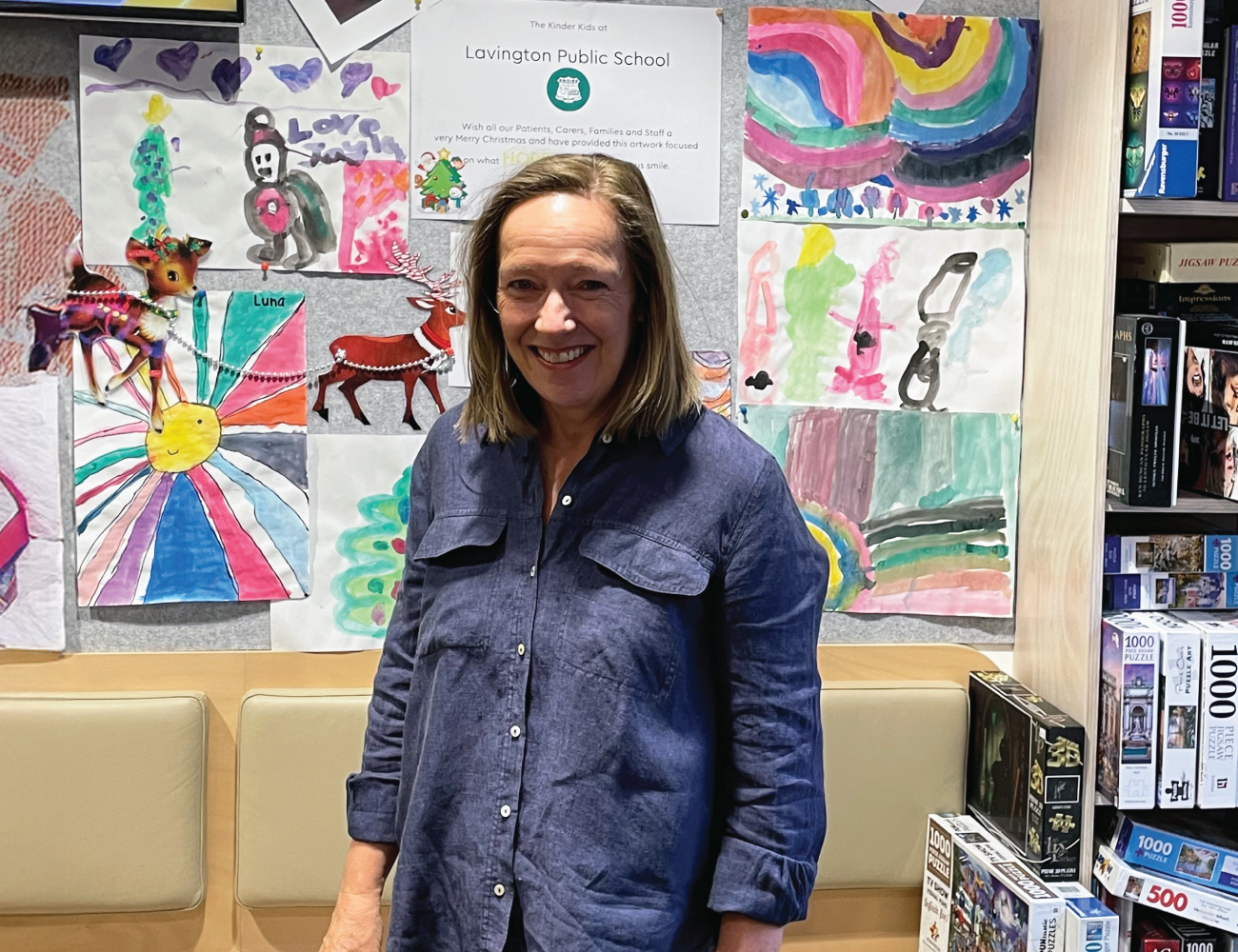 GenesisCare patient Melissa pictured in front of the artworks