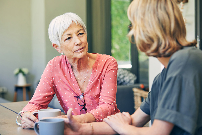 Shot of a mature woman and her elderly mother having coffee and a chat at home