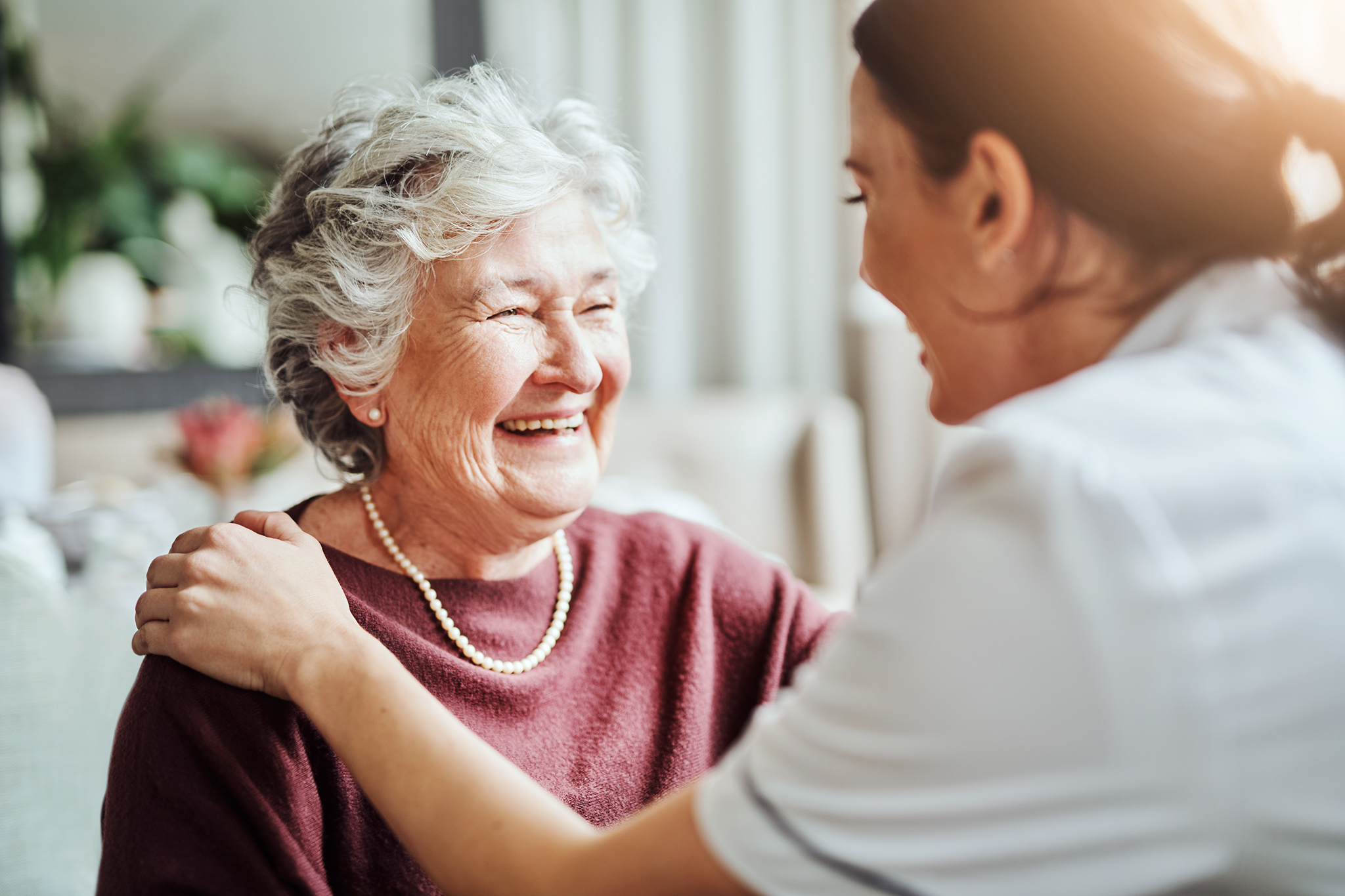 Shot of a young nurse caring for an elderly woman in a retirement home