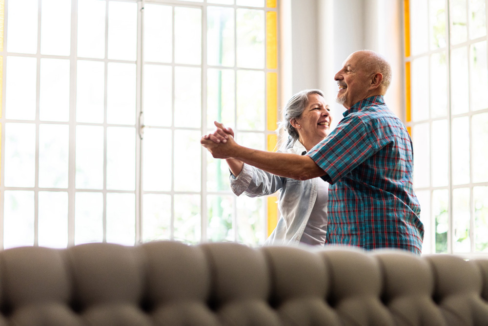 Argentinian, married, elderly couple dancing during at home