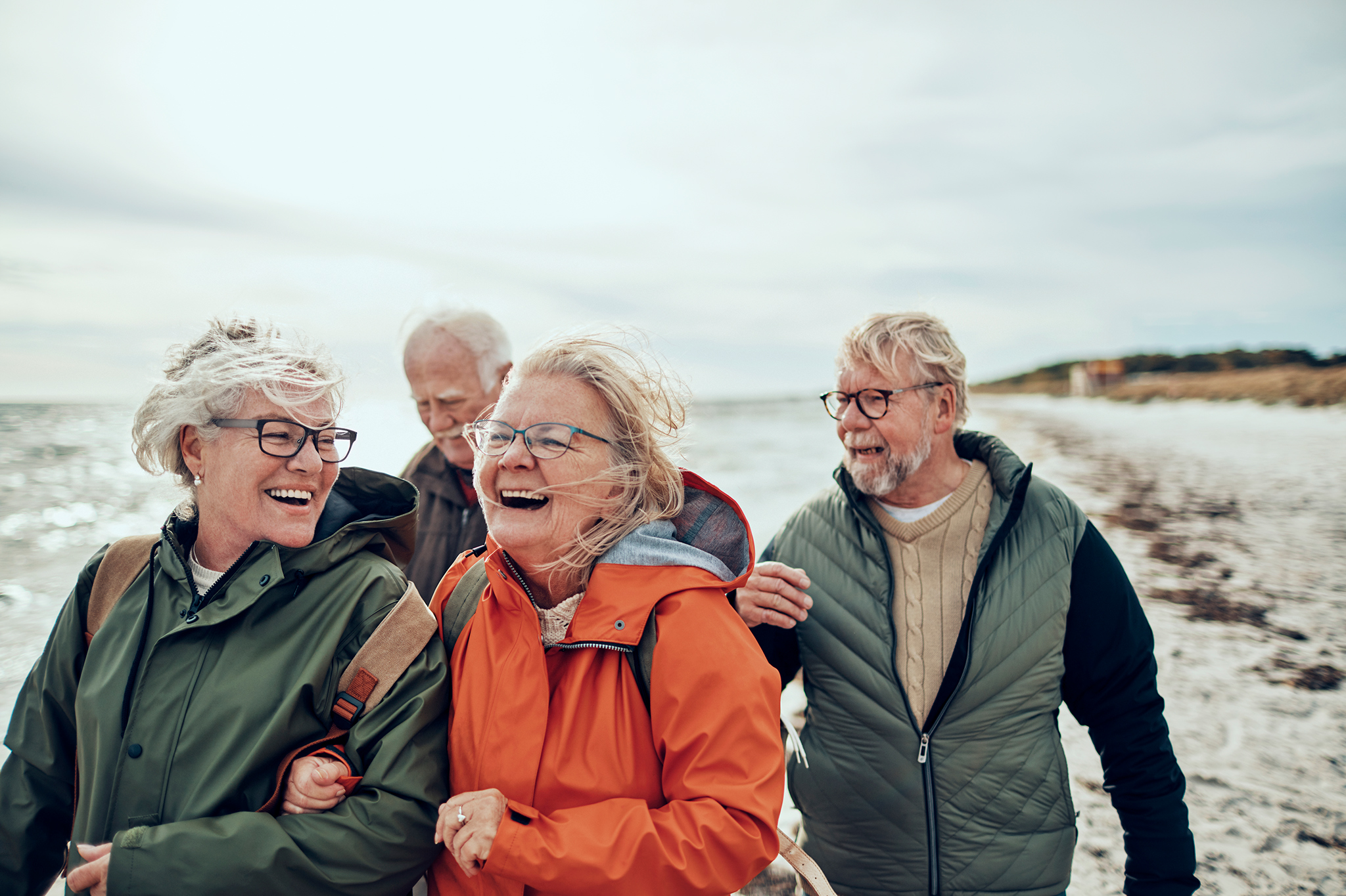 Close up of a group of seniors taking a walk by the beach