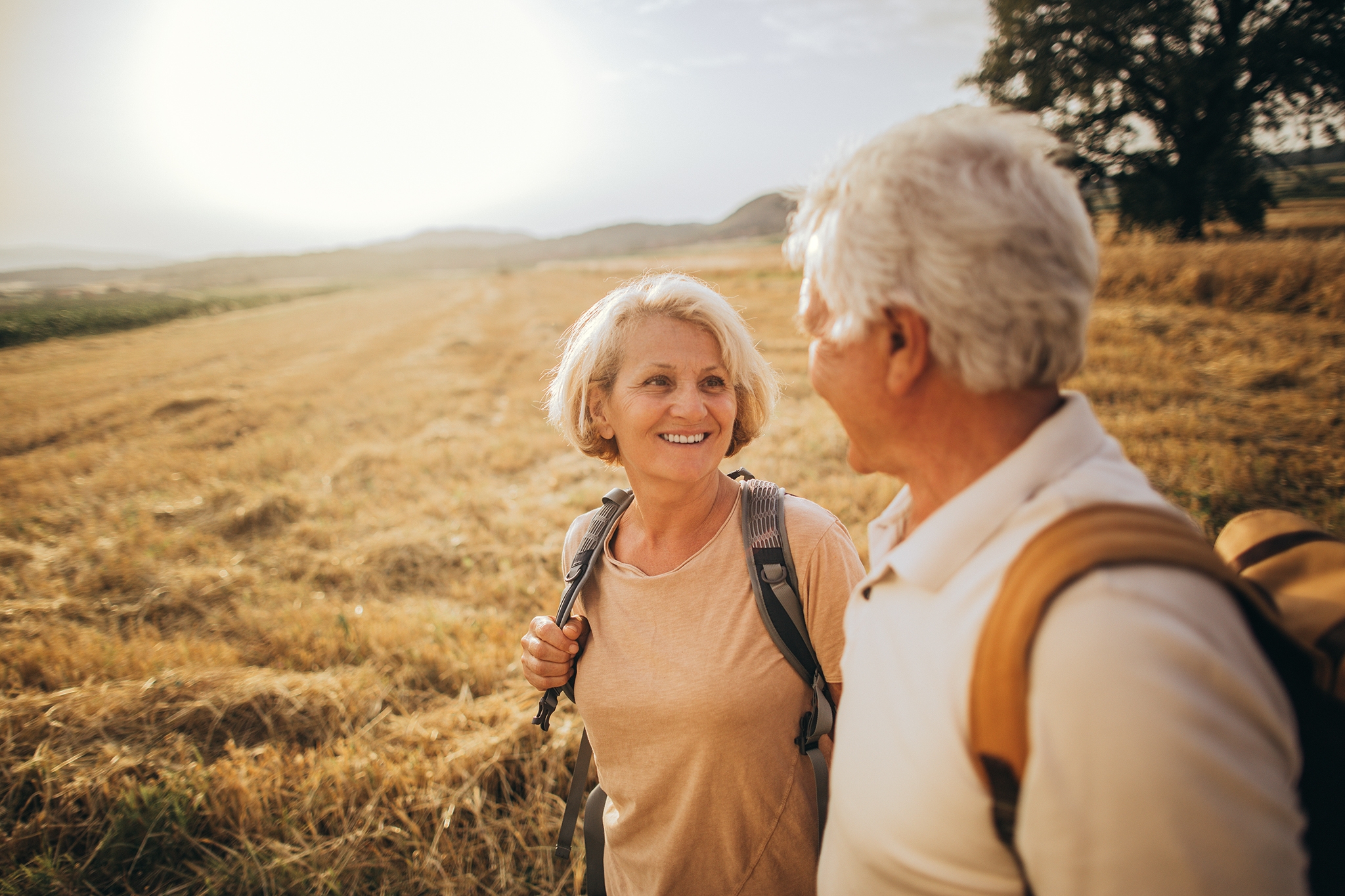 Photo of an elderly couple who still enjoy making memories, searching for new adventures while backpacking