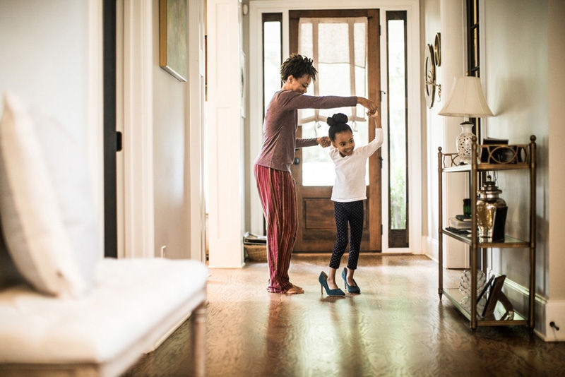 Daughter wearing mother's high heels