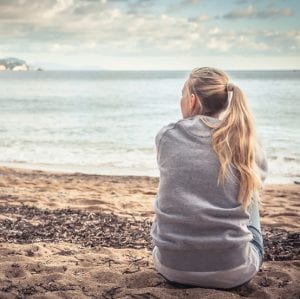 Woman sitting near the beach