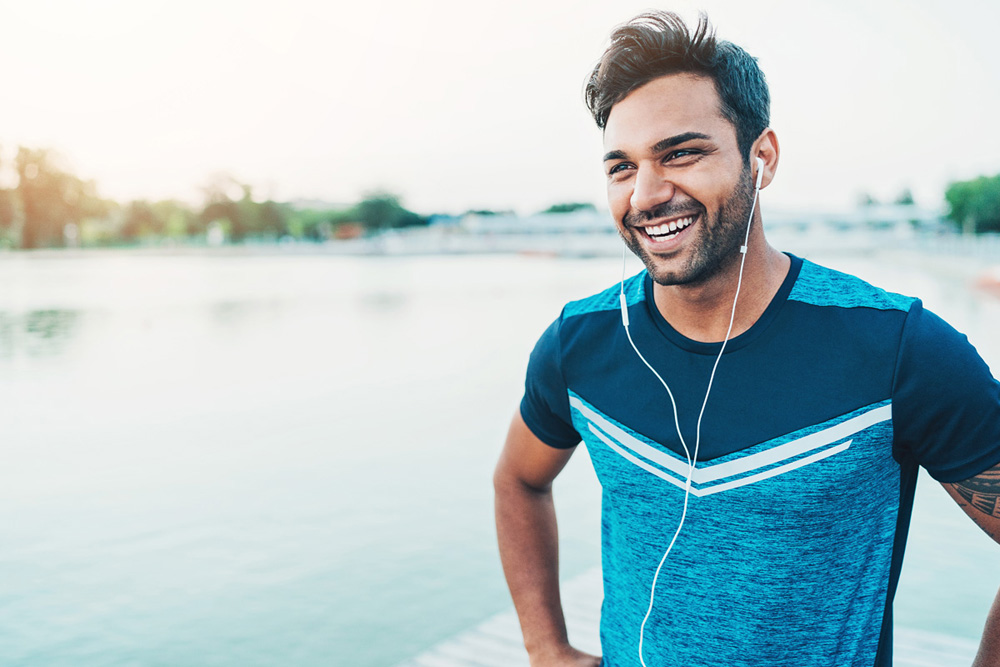 Smiling man wearing earphones